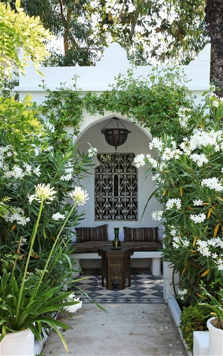 A Moroccan tea pavillion made spectacular by the white agapanthus and oleander leaning into the walkway. (Photo: Jean-Francois Jaussaud)