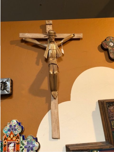 A charming humble straw and wood crucifix on a wall of many, Arte de la Vida.