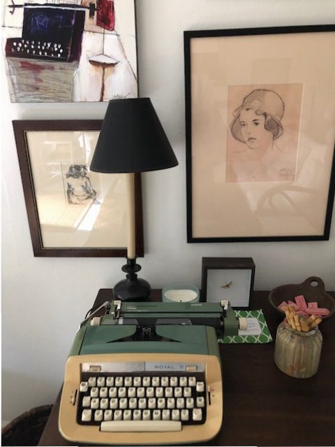 Laura's traded art with Dennis Campay (top left) is perfectly situated above the vintage typewriter. 