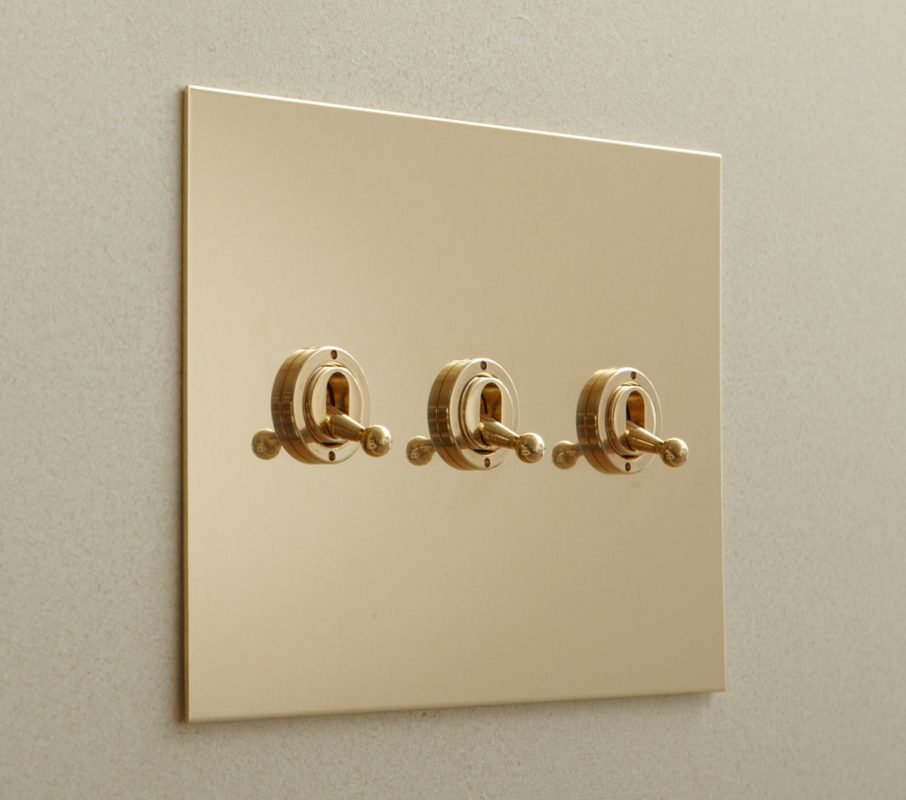 Unlacquered brass toggle switches by Forbes & Lomax.